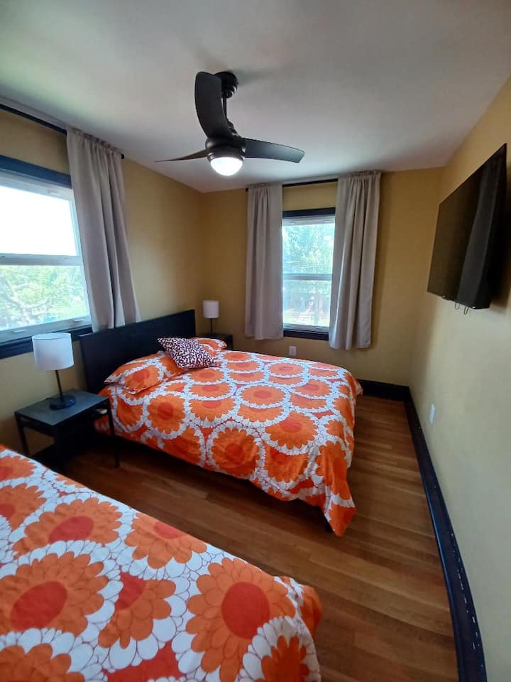 Bedroom 2 - equipped with 1 full bed (sleeps 2 adults), 1 twin bed (sleeps 1 adult), and a 50-inch Roku TV.