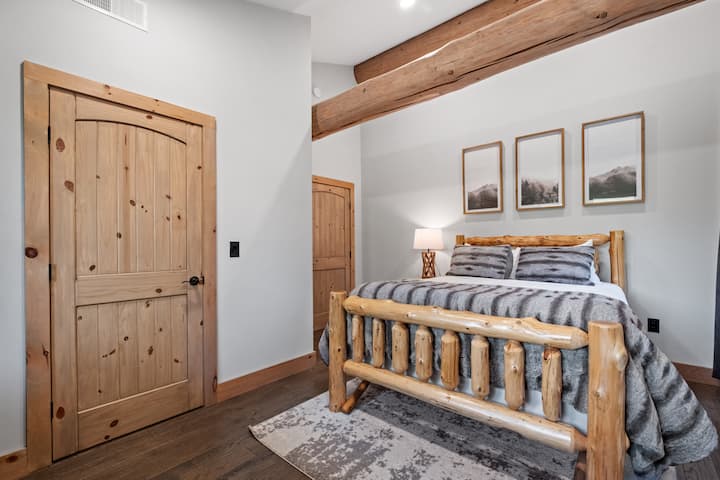 One of two 2nd floor queen bedrooms appointed with black out curtains that will appeal to those with young kids promising a peaceful night's sleep in a cozy and inviting space.