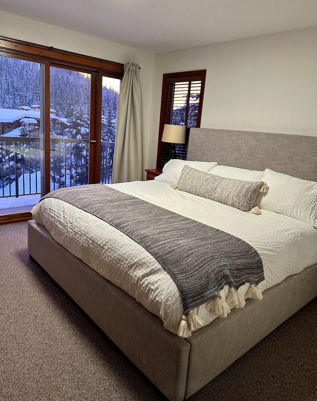 מיטת קינג סייז עם חדר רחצה צמוד ונוף להר מוריסי. יש שני ארונות, ארון בגדים גבוה ושני שידות לילה ומנורות.