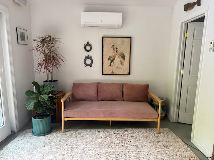 This is a separate pool house at the back of the property. Queen size bed, couch that is comfortable to sleep on. Travertine table. Peleton. Half bath. Outdoor shower. Split unit heat/AC. Ceiling Fan.