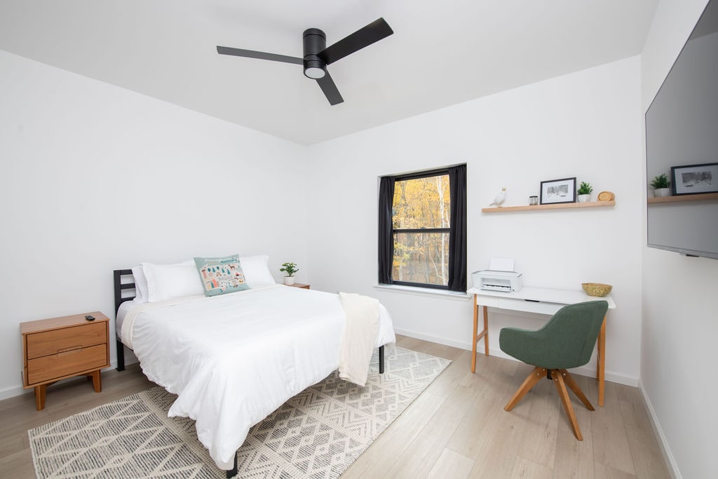 Charming queen bedroom with a private bathroom and workspace for remote working.