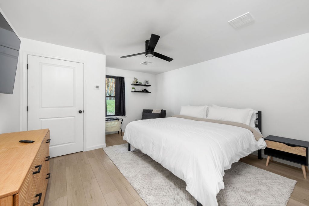 Relax in this cozy king bedroom featuring a Smart TV and easy access to a private bathroom.