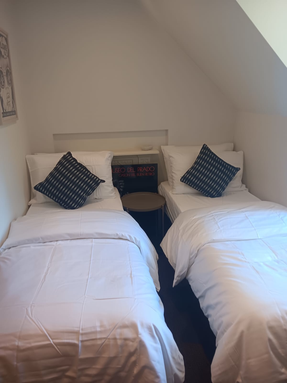 ห้องนอนที่ 2 มีเตียงเดี่ยว 2 เตียงพร้อมโต๊ะข้างเตียงอยู่ตรงกลาง