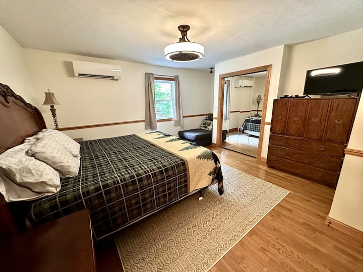 Upstairs bedroom-king bed, closet, dresser, chaise lounge sofa, tv, attached bathroom.