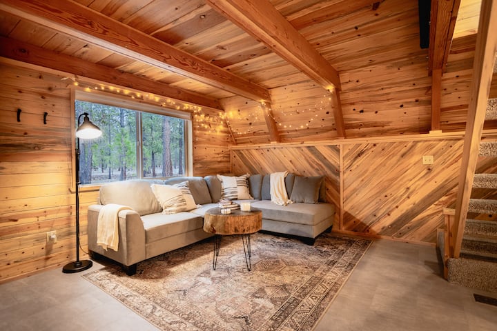 Couch converts to sofa bed and full size air mattress is provided for additional sleeping arrangements. Comfortable bedding, extra pillows, and portable fan are included.