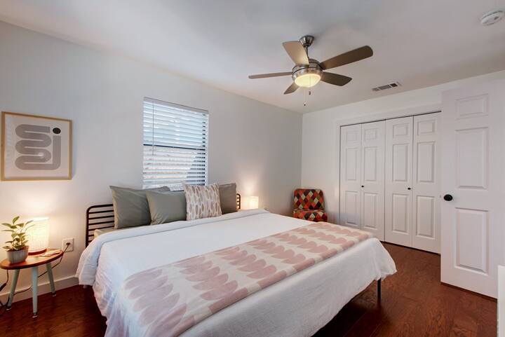Our East Austin home features a large primary bedroom with a king size bed, sitting area, and TV with AppleTV and Netflix. The king bed features a super comfortable memory foam mattress topper for a restful night's sleep.