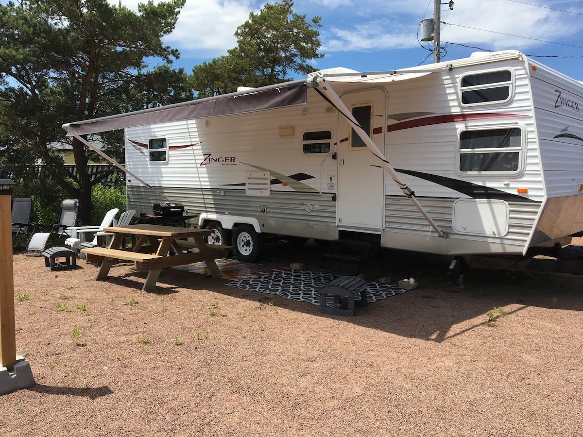 Camper and picnic table on a clear summer day