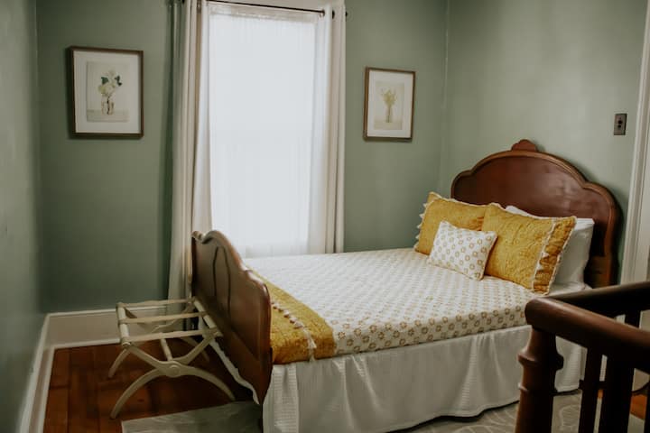 Ein großes Bett befindet sich auf dem Treppenabsatz oben an der Treppe, direkt außerhalb des Hauptschlafzimmers 