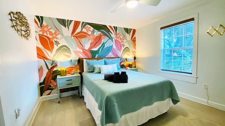 Downstairs bedroom with a queen bed.  We love the wallpaper!