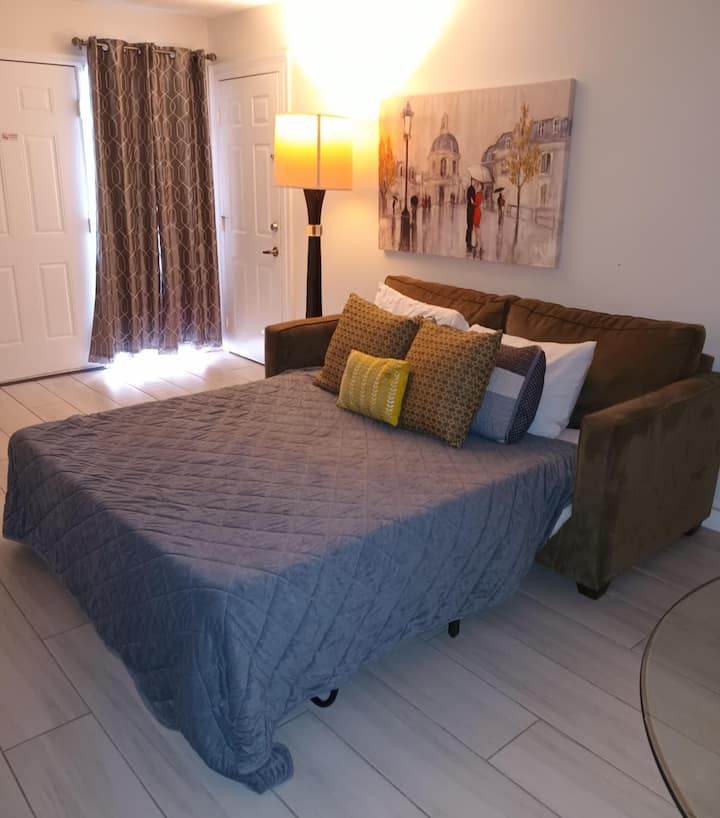 Kitanda cha sofa chenye starehe na televisheni janja mpya yenye programu zote unazopenda za kutazama mtandaoni.