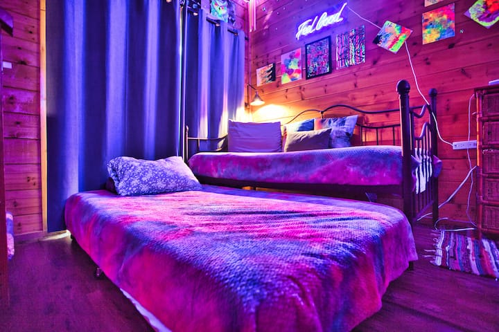 We have blackout curtains for our guests to sleep longer and for daytime use in the blacklight room! The bottom bed pulls out, so there are two twins. 