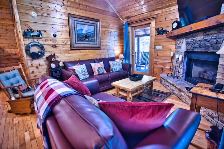 Our cozy living room has vaulted ceilings and bright windows. We have a gas fireplace, queen pull-out, love seat, rocker, and a large smart TV!