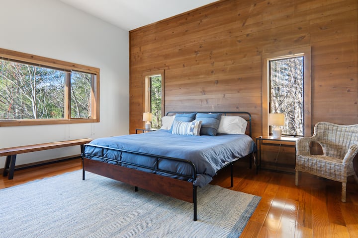 Bedroom two is the master of the lower floor, tucked back into a corner for ultimate privacy. This bedroom features a king size bed, an ensuite bathroom with a shower and a desk if you must work on vacation.