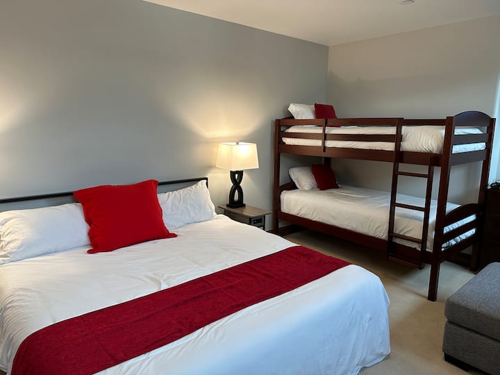 Una cama tamaño king y literas individuales con capacidad para 4 personas con un amplio espacio y puertos de carga USB.