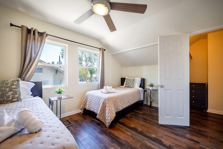 Charming Bedroom Retreat: Bright windows and stylish decor invite relaxation after your adventures!