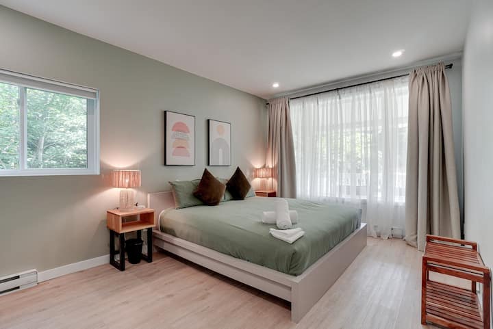 Bedroom 1 with a King bed on the main floor overlooking a small water runoff stream. Hint: leave the side window cracked open during the summer months to hear the sounds of the stream. 