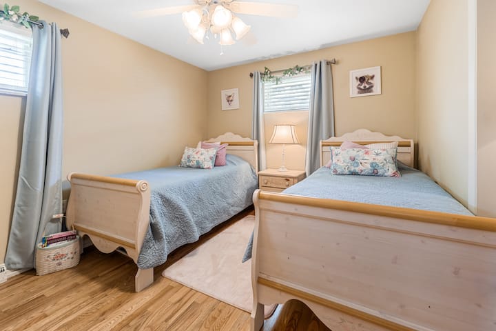 Two twin beds with comfortable bedding, all linens provided.