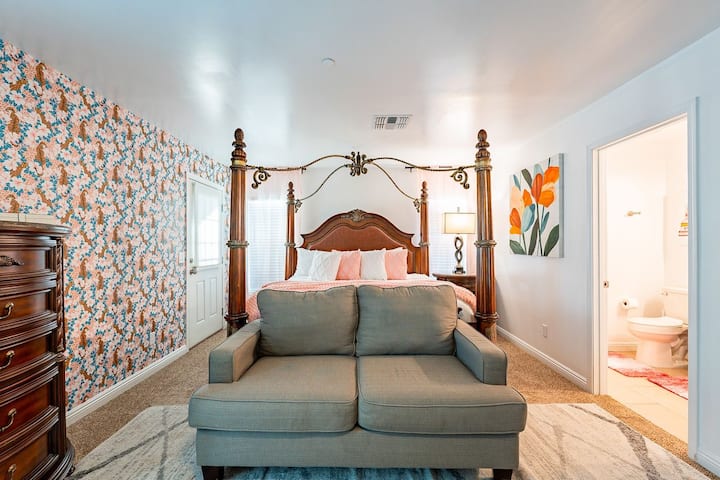 Say hello to your jaw-dropping master suite — complete with a grand four-poster bed, plush loveseat, and a peek into your private en suite. Oh, and yes, that fierce jaguar wallpaper? She’s serving looks all night long.