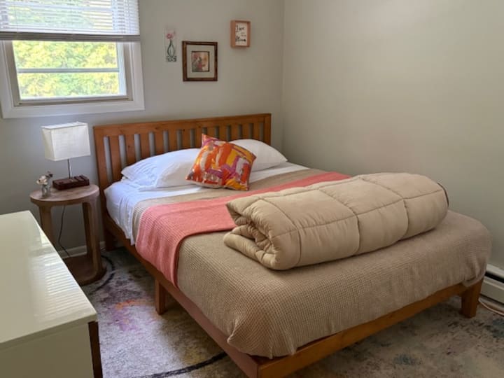 This is the Garden Room. It is closest to the bathroom. There is an air-conditioning room in this room as well, along with a ceiling fan. The USB ports are in the light on the nightstand. Memory foam mattress and extra pillows.