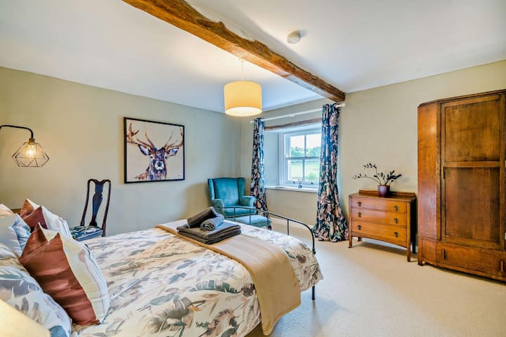 Peaceful king bedroom with soft linens and village green views.