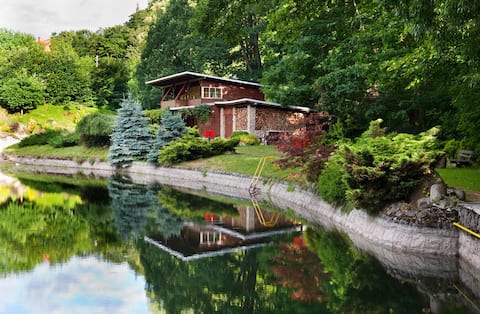 Beautiful wooden house with a large swimming pond