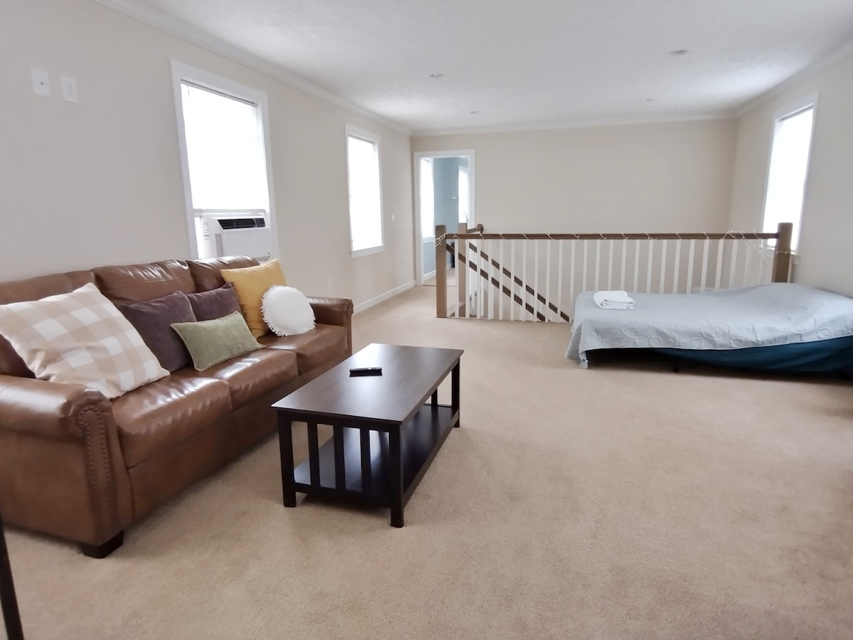 Second floor living room with sofa bed, recyliner and TV