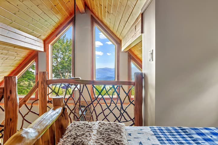 Loft sleeping area with queen bed and forever mountain views. 