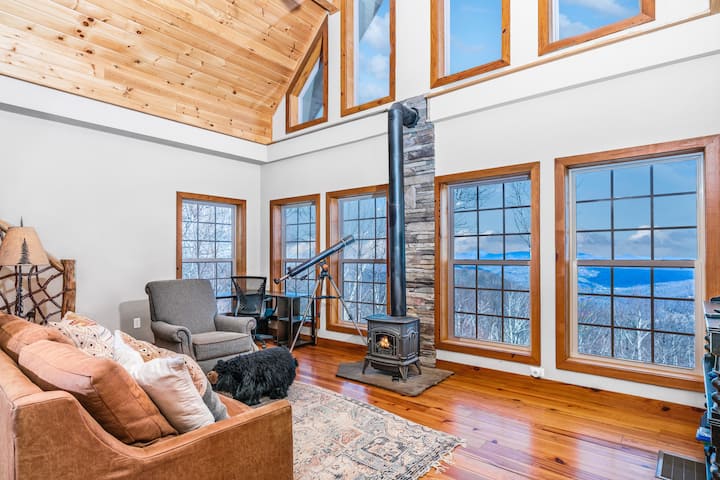 Attached, private loft featuring floor-to-ceiling windows and expansive mountain views, offering a bright and inviting space to relax and take in the scenery