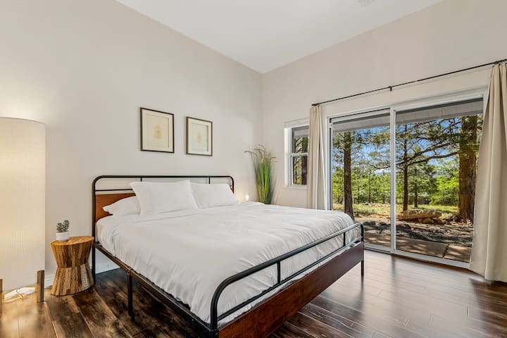Large king bed with memory foam mattress topper, patio to backyard and desk in closet.