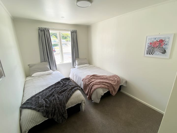 The second bedroom includes 2 king single beds and a wardrobe.  Room size is 12m².
