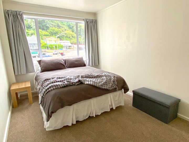 First bedroom includes a Queen-sized bed and wardrobe. Room size is 12m².