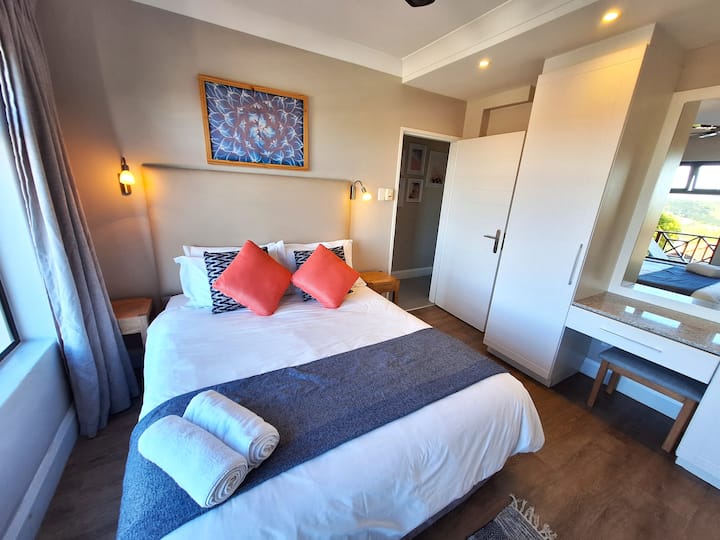 The second bedroom, with ample cupboard space, opens onto the first-floor balcony, offering a tranquil space for relaxation and a restful night's sleep.