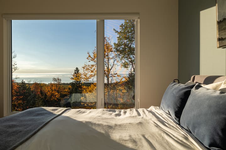Bedroom with queen bed. Each of the four bedrooms is equipped with a queen bed, chair and storage space for clothes.