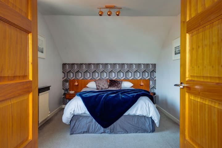 Large bedroom on the upper level with king size bed (European king), ensuite bathroom and private lounge area including sofabed.