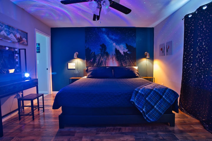 We can't wait for you to relax in the master bedroom with our cozy lighting on the tapestry, side lamps, and the aurora light! There are blackout curtains, a reading nook, a full closet, an area to sit and get ready, and a full-length mirror.