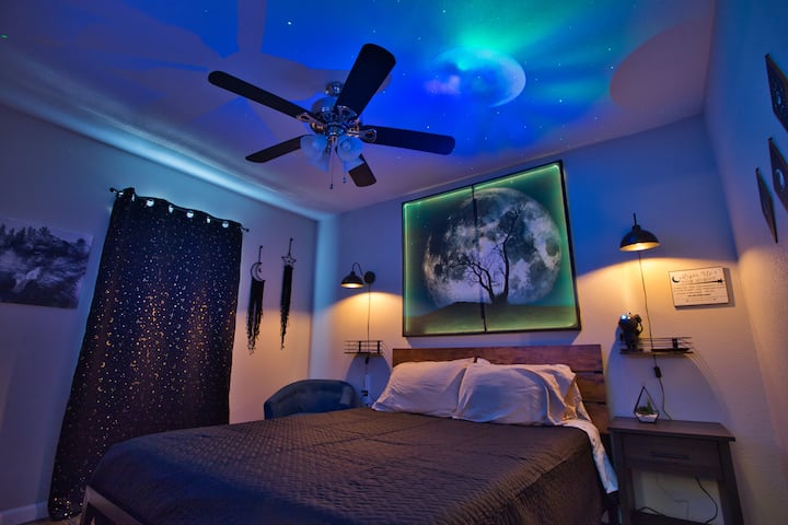 There is a queen-size bed in the second bedroom. We have blackout curtains and the tapestry behind the bed lights up and we have an aurora astronaut projector!