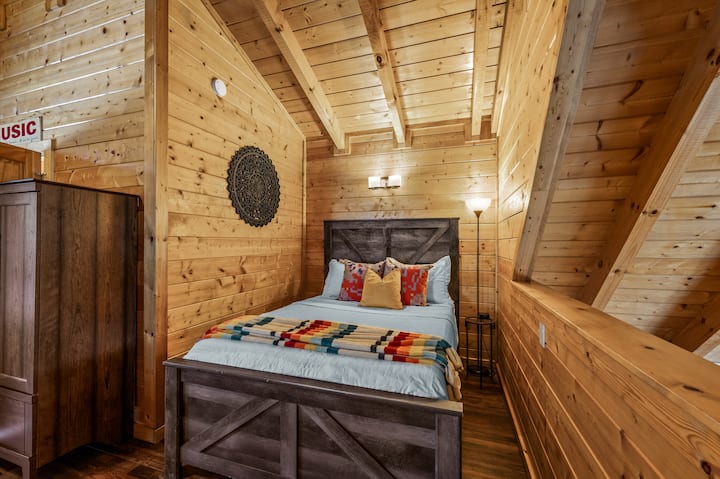 Queen size bed in the music-themed open loft