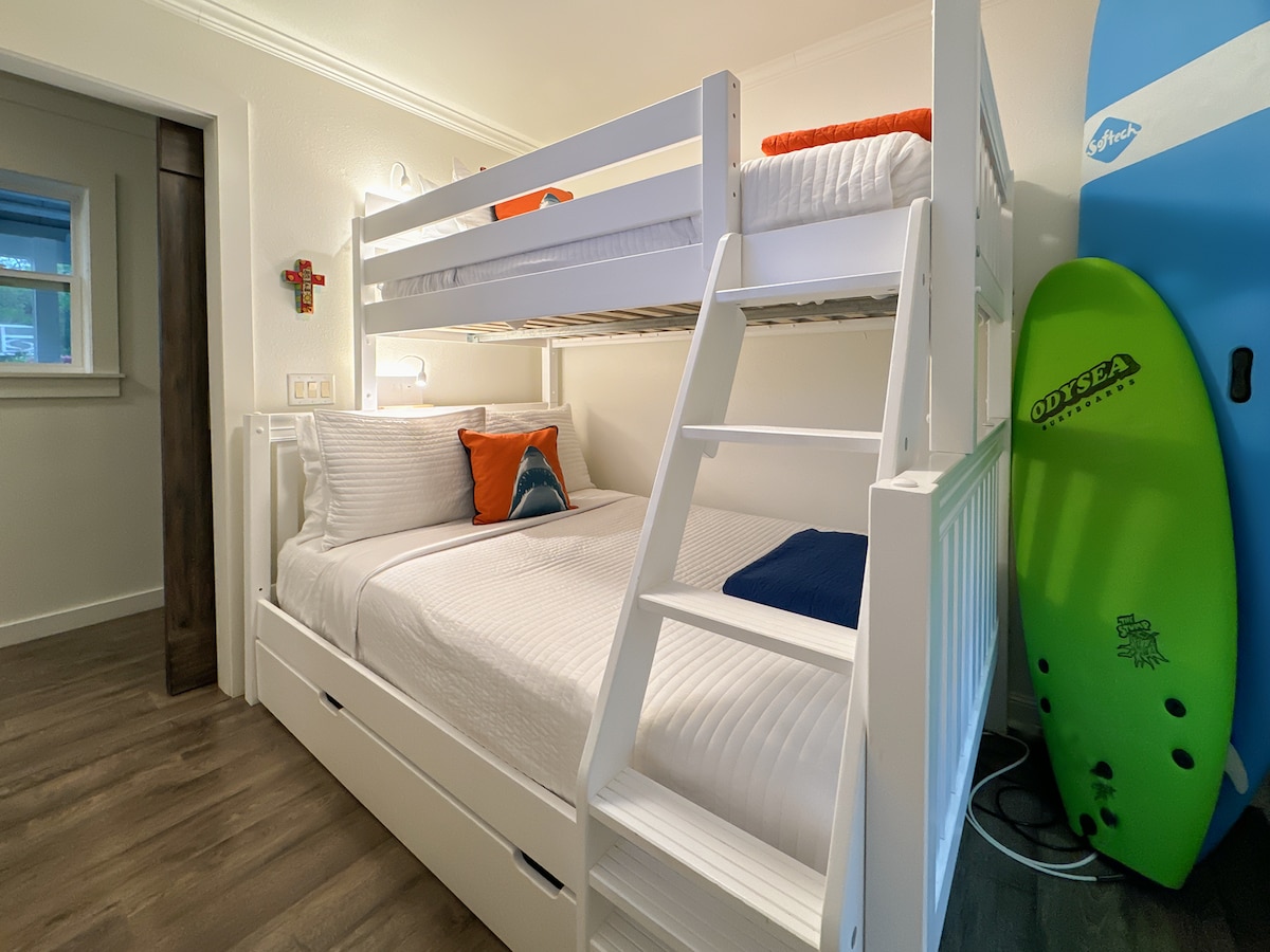 Spavaća soba za goste s bračnim krevetom na kat i ladicama ispod kreveta.