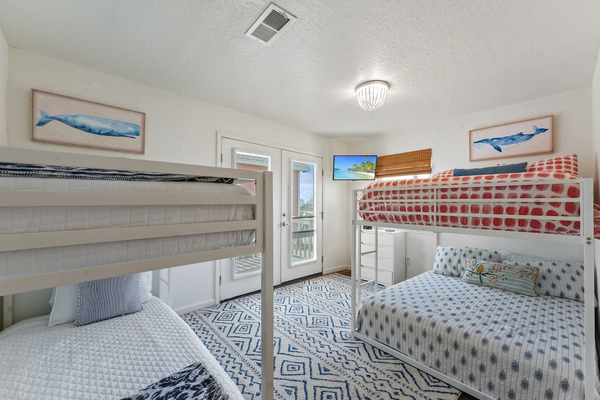 Next, the 2nd bedroom features two bunk beds, one full-size and one twin, ensuring a comfortable place to sleep that is ideal for the kids. Soft linens and cushions await to relax and rejuvenate the little ones after fun-filled days at the beach.
