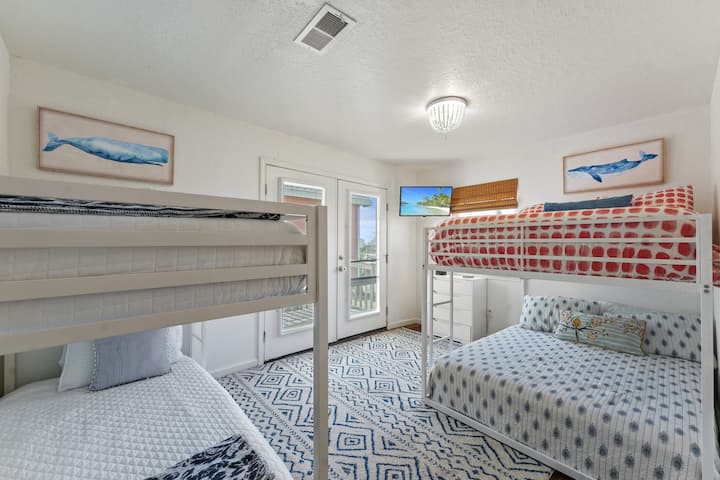 Next, the 2nd bedroom features two bunk beds, one full-size and one twin, ensuring a comfortable place to sleep that is ideal for the kids. Soft linens and cushions await to relax and rejuvenate the little ones after fun-filled days at the beach.
