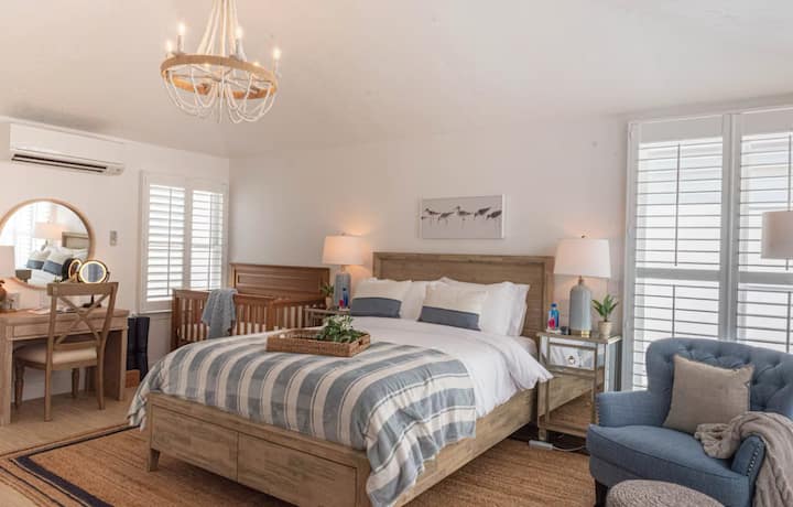 This is a picture of the detached studio where there is a queen bed, crib, office desk, bathroom, kitchen and dining table for 2. The detached studio accommodates a maximum of 2 people. Please read entire listing or ask host for more details.