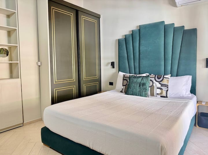 Bedroom 2 includes a Queen size bed (160 x 200cm), closet, dresser, and access to the side balcony. 