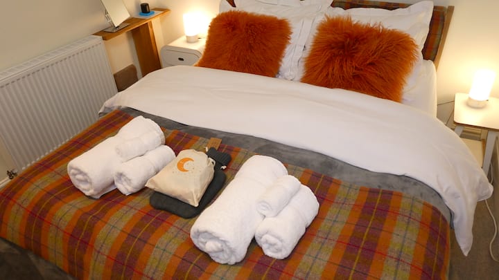 This bedroom has a king size bed. It also has an en suite bathroom.