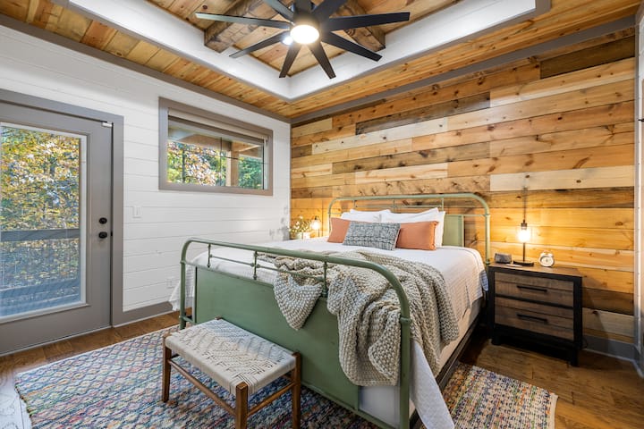 Enjoy the secondary bedroom, complete with a king-sized bed, soft lighting, and direct patio access for a peaceful morning coffee.