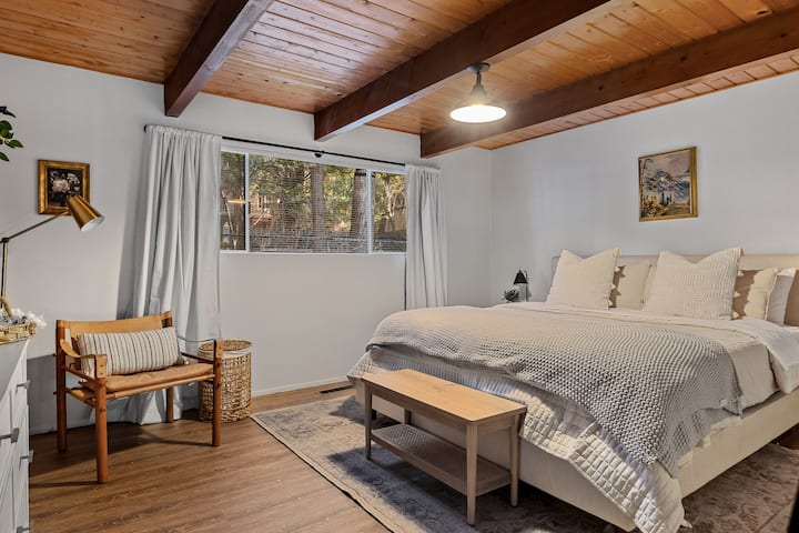 The Main bedroom is on the main floor and has a king bed, dresser and tv. 