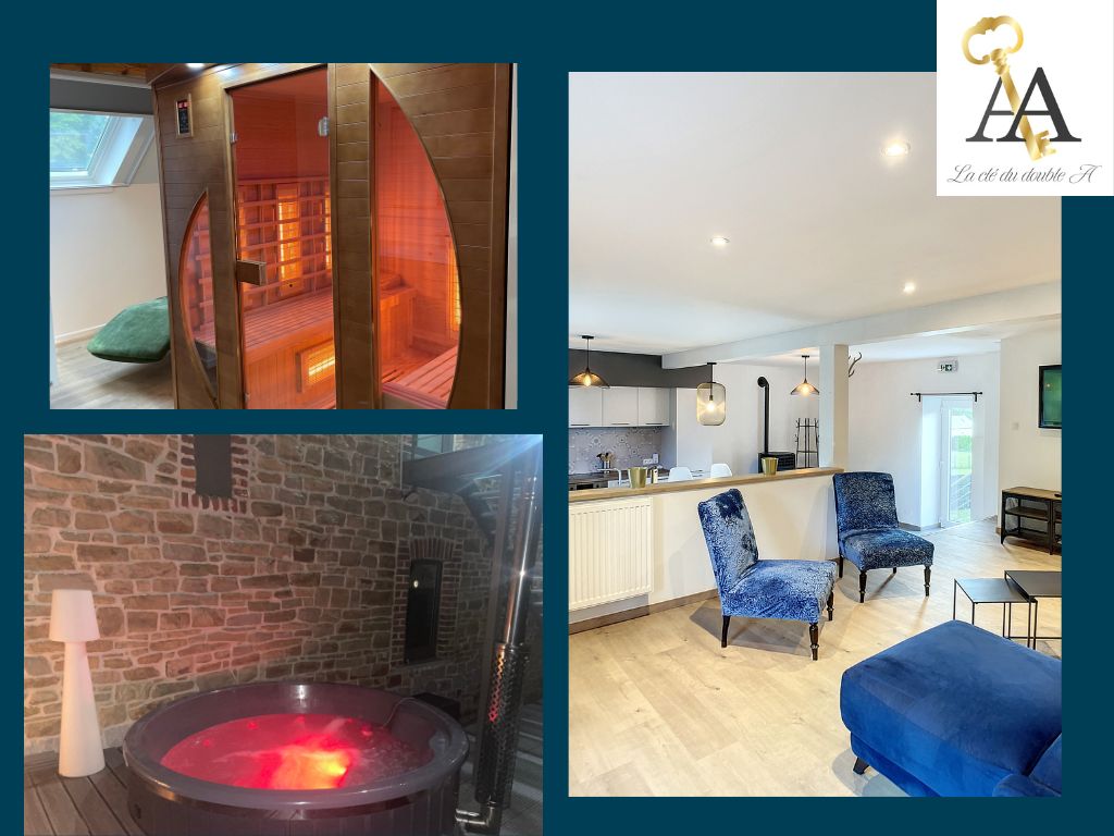 An inviting wellness area showcases a spacious sauna with soft lighting and wooden interiors, alongside a bubbling jacuzzi illuminated in vibrant colors. Modern furnishings, including two stylish blue chairs and a cozy couch, complement an open-plan living space featuring a well-equipped kitchen.