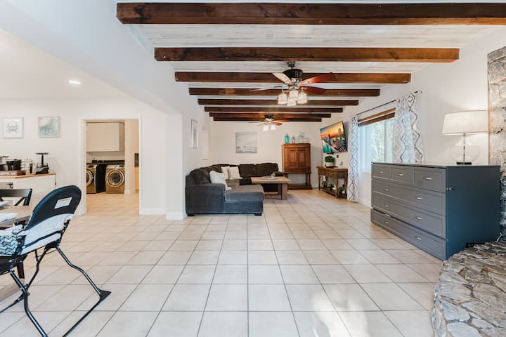 A space designed with families in mind—our cozy TV room with Murphy bed flows right into the kitchen & coffee bar and a highchair is ready for your little one, making mealtime and together time easy and stress-free