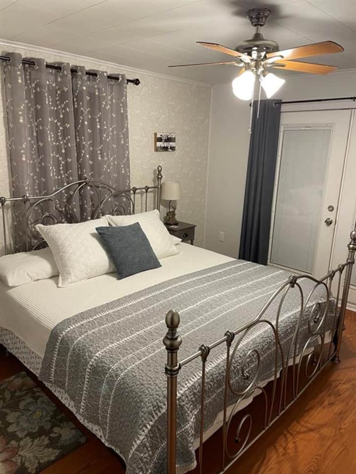King size bed. Very clean, comfortable space to sleep. Doors to the wrap around deck.  Lake view.