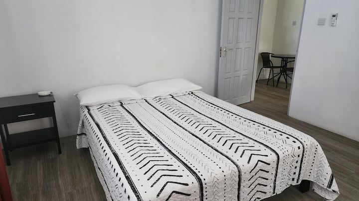 Large bedroom with queen bed and AC