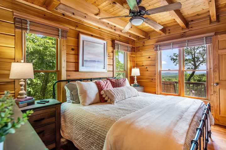 Main-level king suite with cozy bedding, Smart TV, and private en-suite bath.